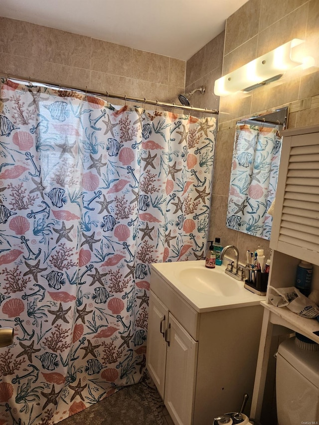 bathroom featuring vanity, a shower with shower curtain, tile walls, and toilet