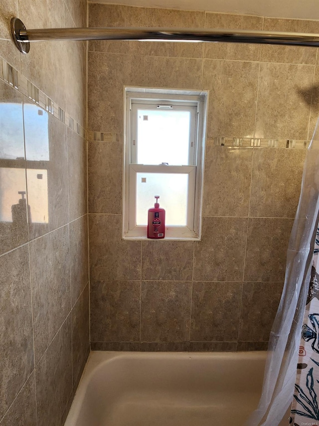 bathroom with shower / bath combo with shower curtain