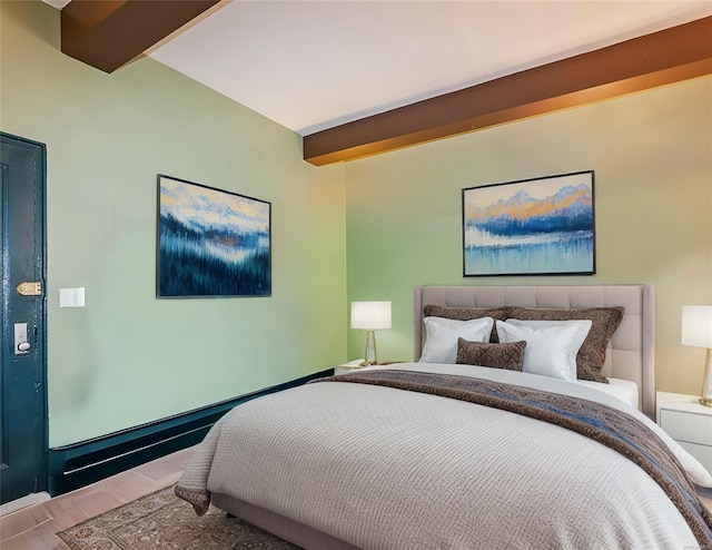 bedroom with beamed ceiling and wood-type flooring