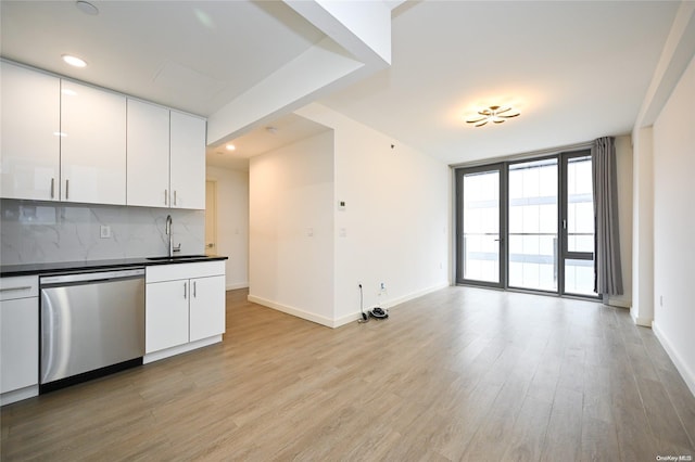 kitchen with tasteful backsplash, sink, dishwasher, light hardwood / wood-style floors, and white cabinetry