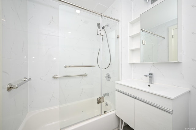 bathroom featuring decorative backsplash, shower / bath combination with glass door, and vanity