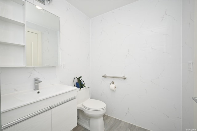 bathroom with vanity, hardwood / wood-style flooring, and toilet