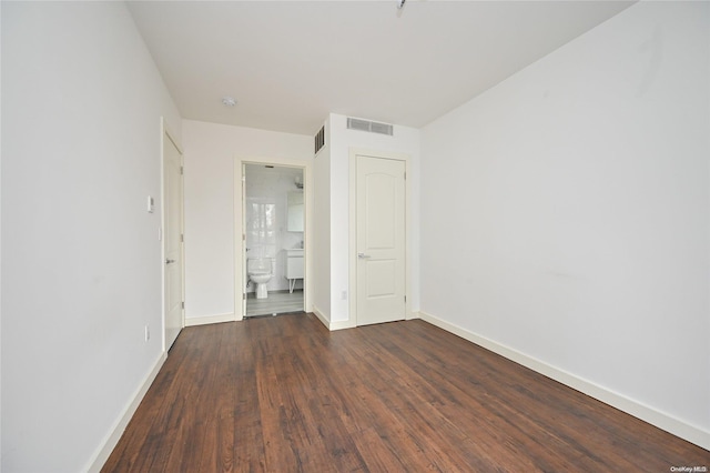 spare room featuring dark hardwood / wood-style floors