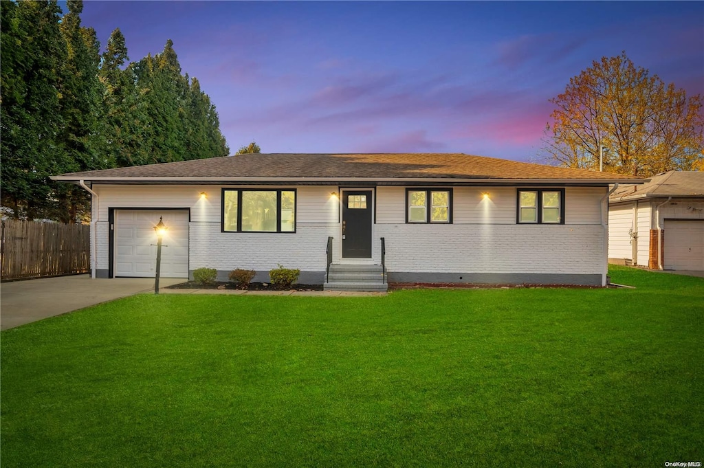 single story home with a yard and a garage