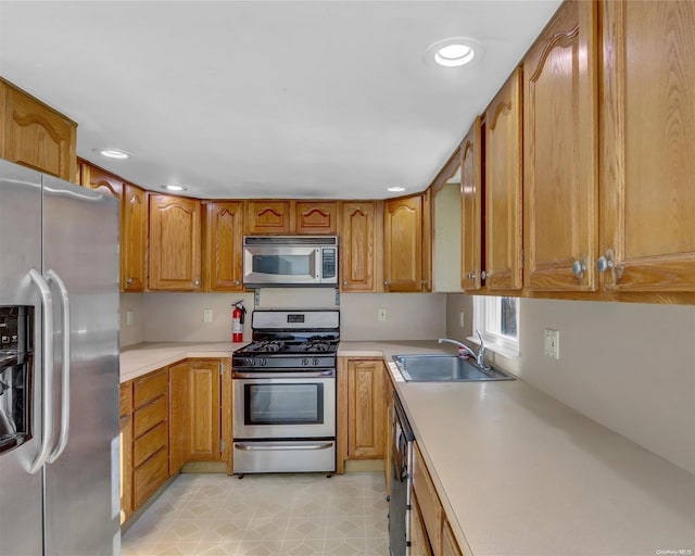 kitchen with sink, light tile patterned floors, and stainless steel appliances