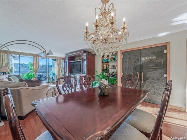 dining room featuring a textured ceiling and light hardwood / wood-style floors