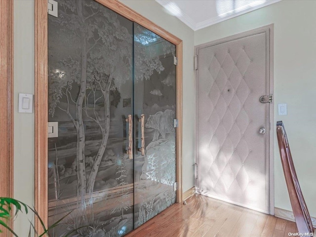 interior space featuring hardwood / wood-style flooring and crown molding