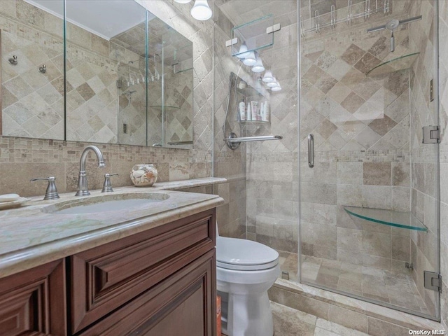 bathroom featuring vanity, backsplash, toilet, tile walls, and an enclosed shower