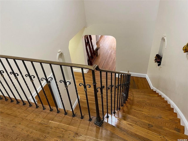 stairway featuring wood-type flooring