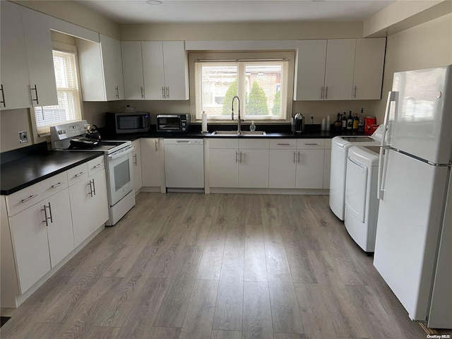 kitchen featuring white cabinetry and white appliances