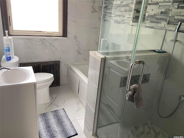 full bathroom featuring plus walk in shower, radiator heating unit, vanity, and tile walls