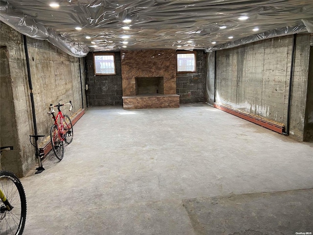 basement featuring a fireplace and a baseboard radiator