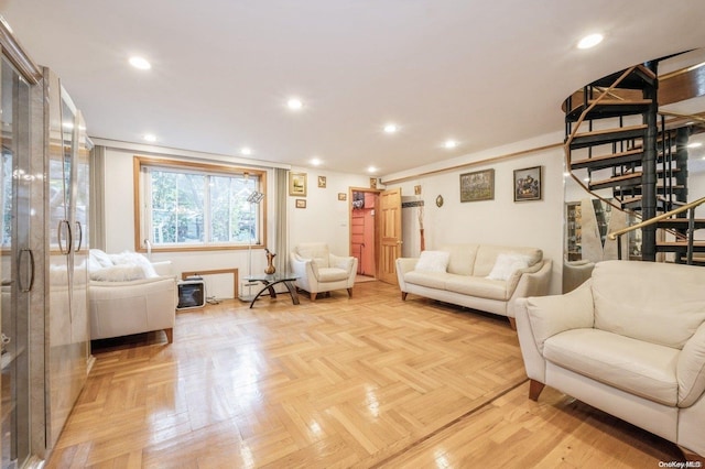 living room featuring a baseboard radiator and light parquet floors