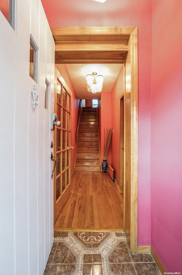 hallway with a notable chandelier