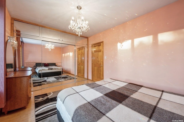 bedroom with an inviting chandelier and a closet