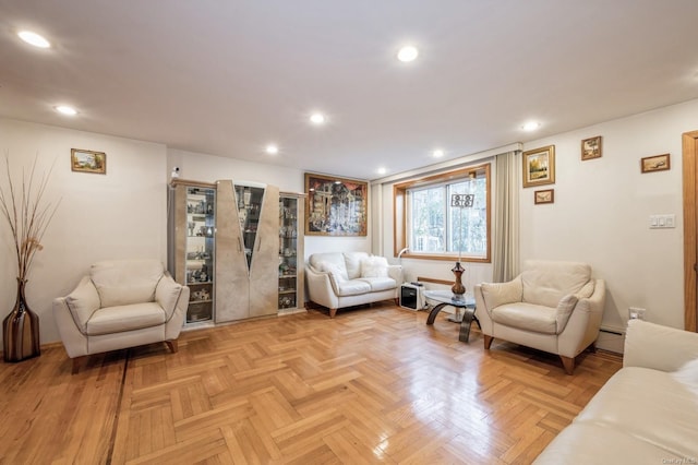 living room featuring light parquet floors and a baseboard heating unit