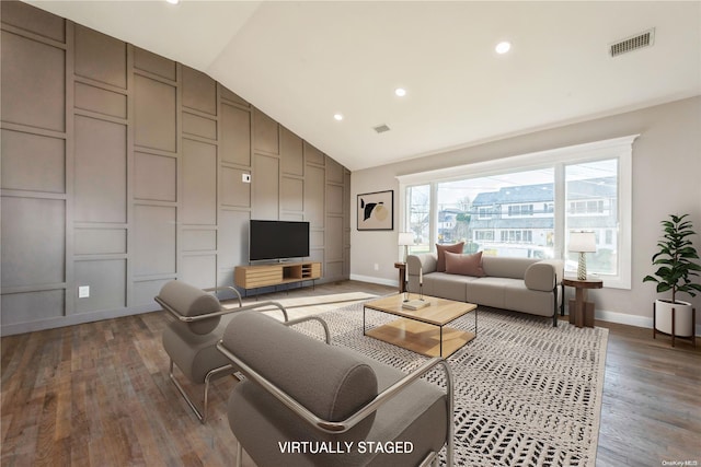 living room with dark hardwood / wood-style floors and vaulted ceiling