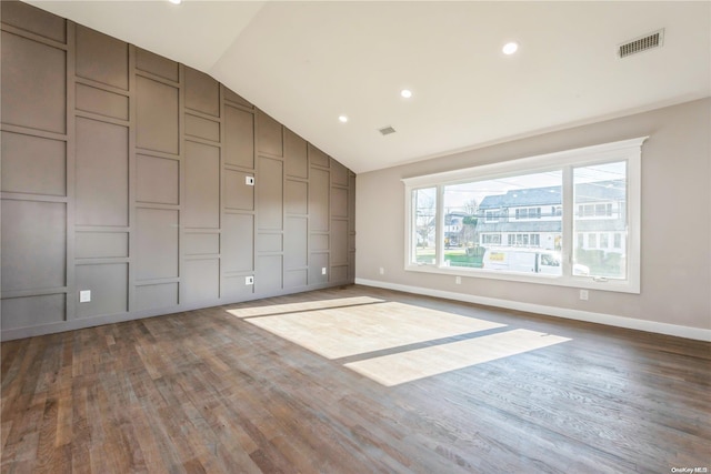 interior space featuring hardwood / wood-style flooring and vaulted ceiling