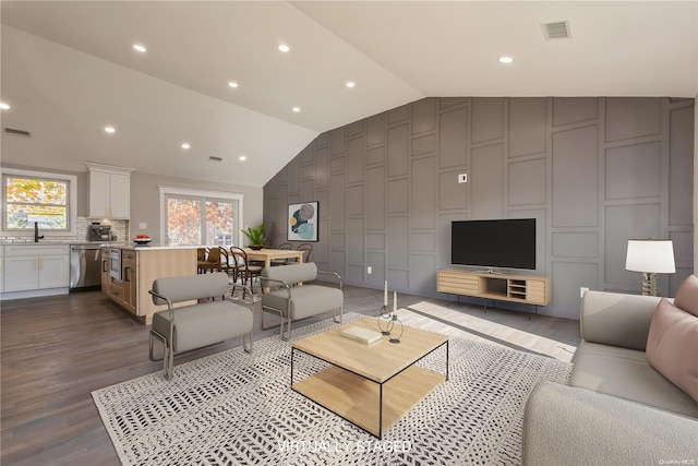 living room with dark wood-type flooring and lofted ceiling