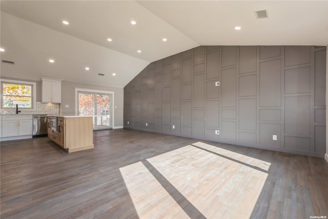 interior space with dark hardwood / wood-style flooring and vaulted ceiling