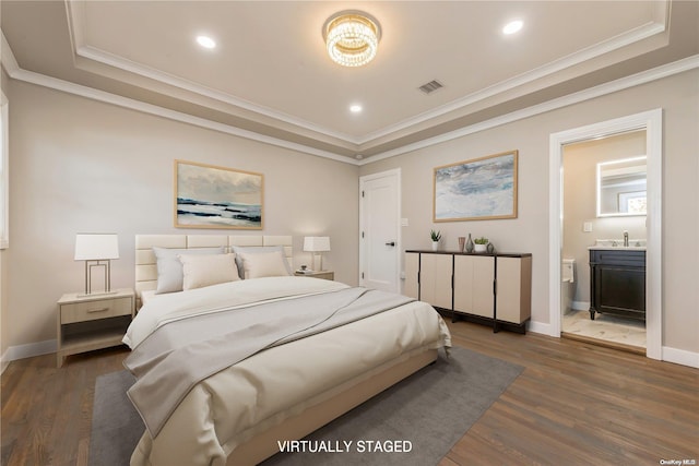 bedroom with ornamental molding, a tray ceiling, and dark wood-type flooring