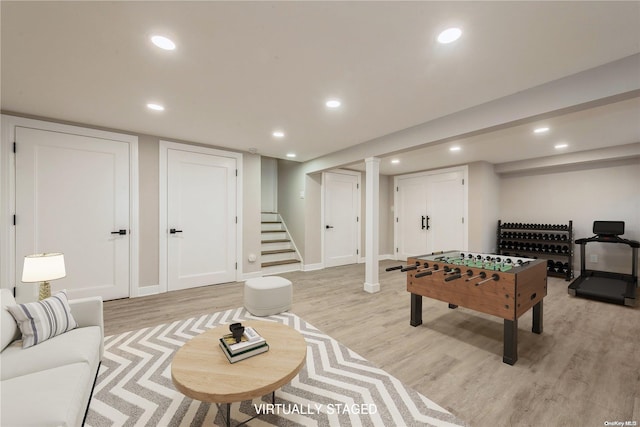 game room with light hardwood / wood-style flooring