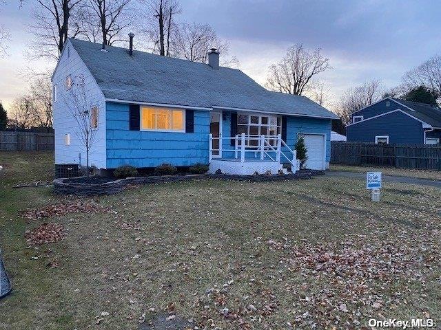 view of front facade with a yard and a garage