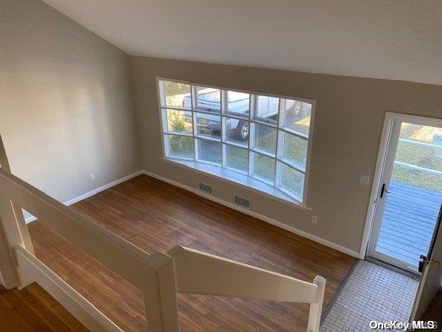 interior space featuring lofted ceiling and hardwood / wood-style flooring