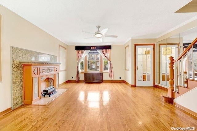 unfurnished living room featuring radiator heating unit, light hardwood / wood-style floors, ceiling fan, and crown molding