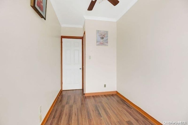 spare room featuring ceiling fan, wood-type flooring, and crown molding