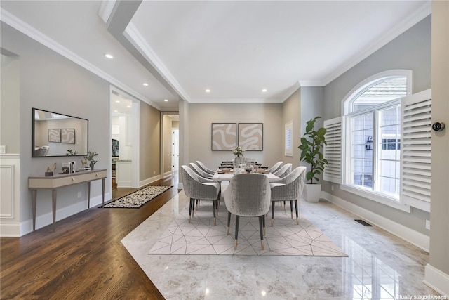 dining room featuring wood-type flooring and ornamental molding