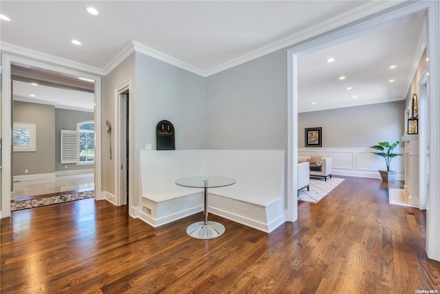 corridor with ornamental molding and dark hardwood / wood-style floors