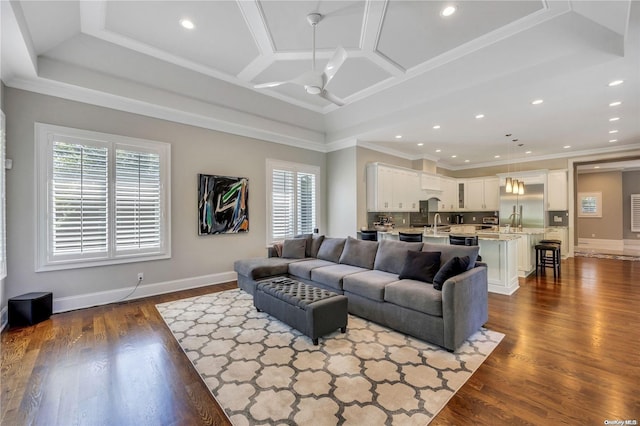 living room with ceiling fan, plenty of natural light, coffered ceiling, and dark hardwood / wood-style floors