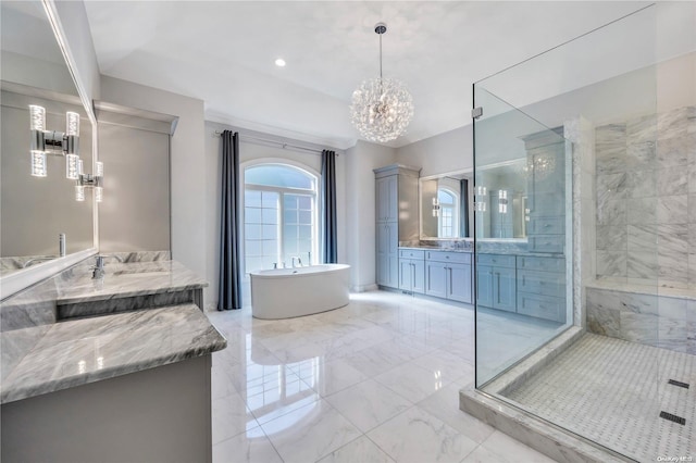 bathroom featuring shower with separate bathtub, vanity, and a notable chandelier