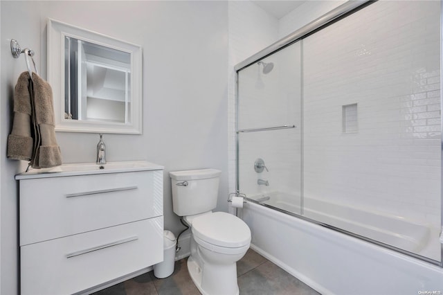 full bathroom featuring toilet, vanity, tile patterned floors, and shower / bath combination with glass door