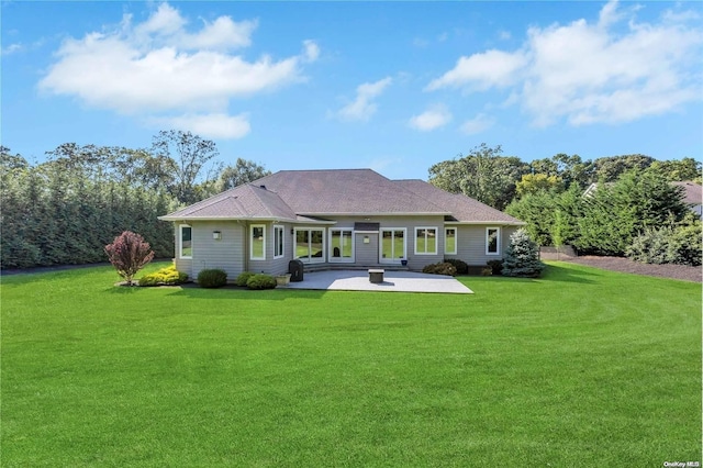 rear view of property featuring a lawn and a patio