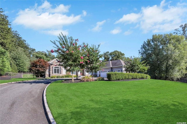 view of property hidden behind natural elements with a front yard