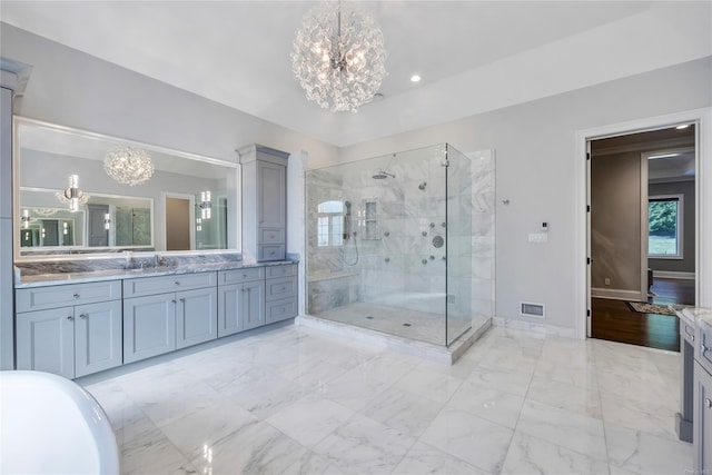 bathroom featuring vanity, a notable chandelier, and independent shower and bath