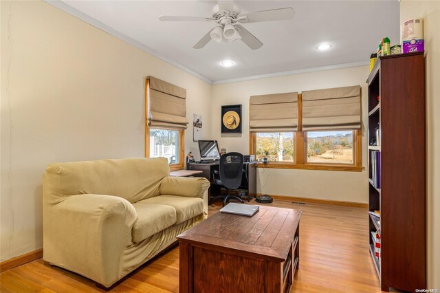 1400 Aldrich Ln, Laurel, NY 11948 - living area with ornamental molding, baseboards, a ceiling fan, a desk, and light wood-style flooring