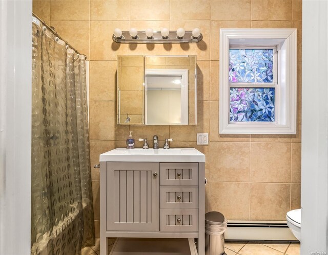 1400 Aldrich Ln, Laurel, NY 11948 - bathroom featuring baseboard heating, tile walls, vanity, toilet, and tile patterned floors