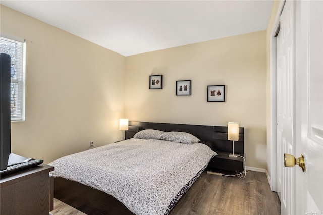 1400 Aldrich Ln, Laurel, NY 11948 - bedroom featuring dark wood-style flooring, a closet, and baseboards