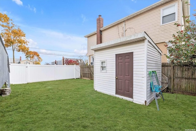 view of outbuilding with a yard