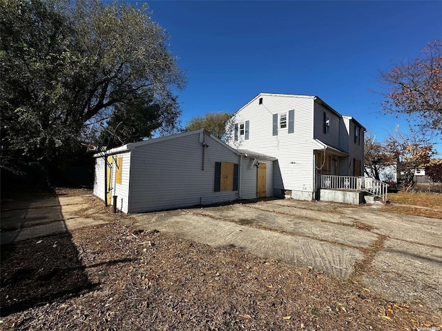 rear view of property featuring covered porch