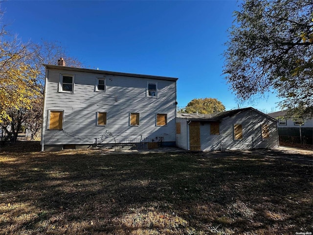 back of property with a lawn