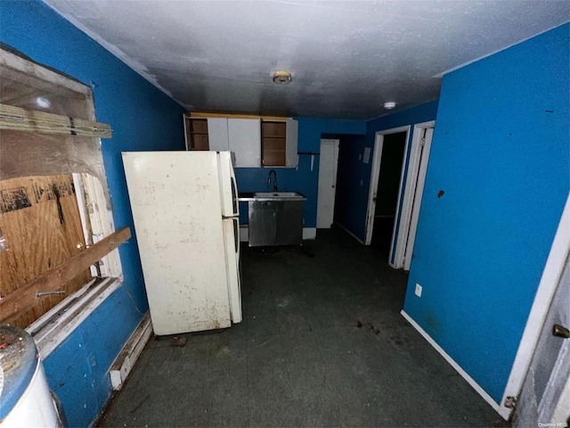 kitchen featuring white fridge and sink