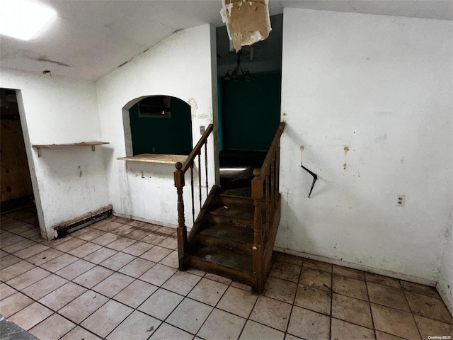 stairway featuring lofted ceiling