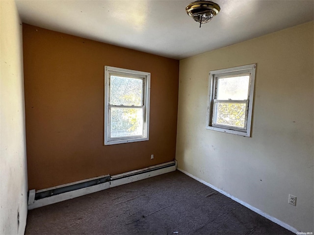 empty room with baseboard heating and a wealth of natural light