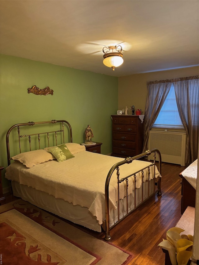 bedroom featuring dark hardwood / wood-style floors and radiator