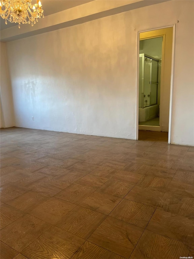 empty room featuring a notable chandelier