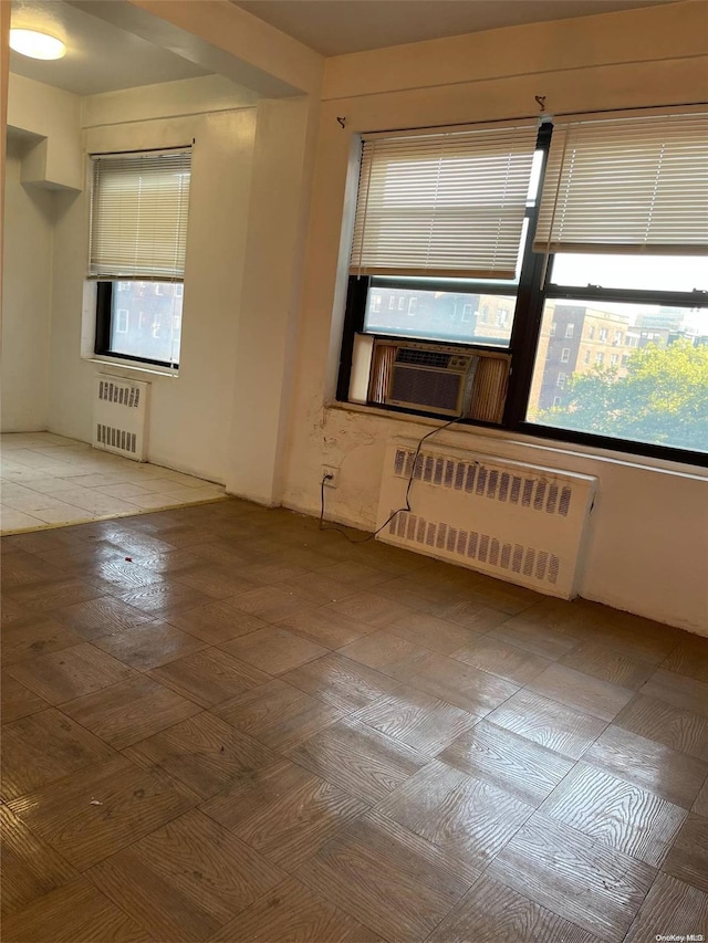 99-40 63rd Rd Unit 5A, Rego Park, NY 11374 - unfurnished room featuring radiator and cooling unit